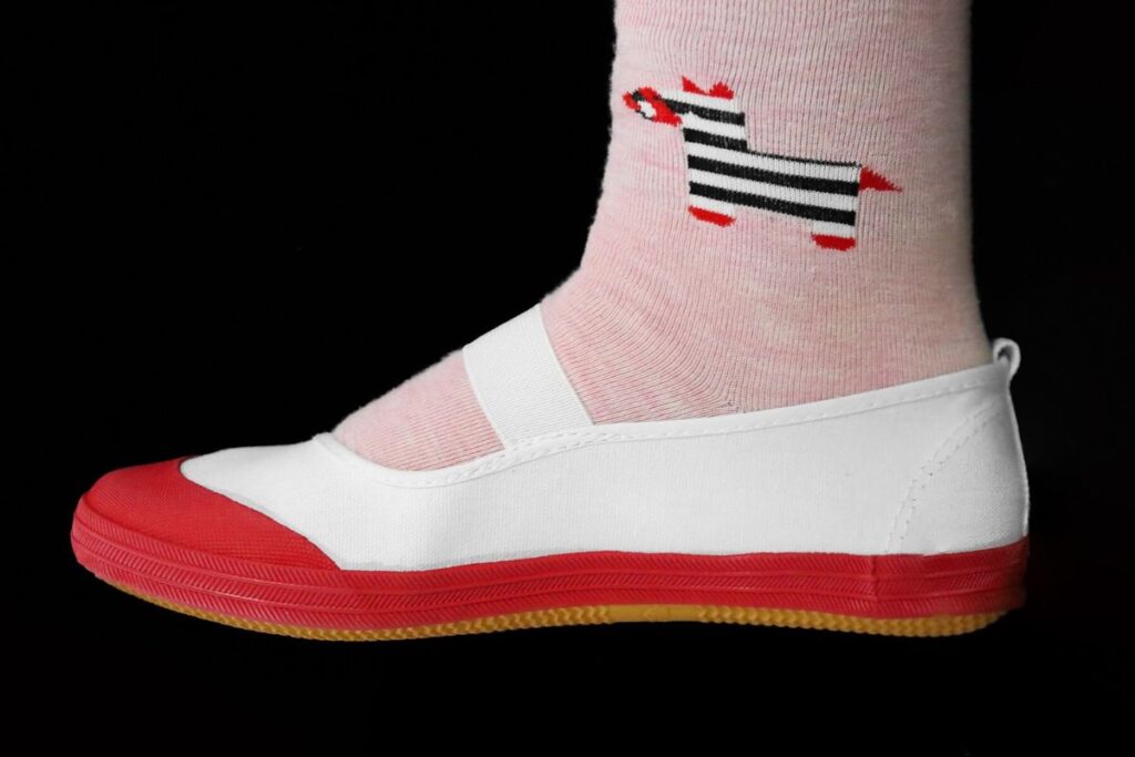 Red Uwabaki worn with socks.
