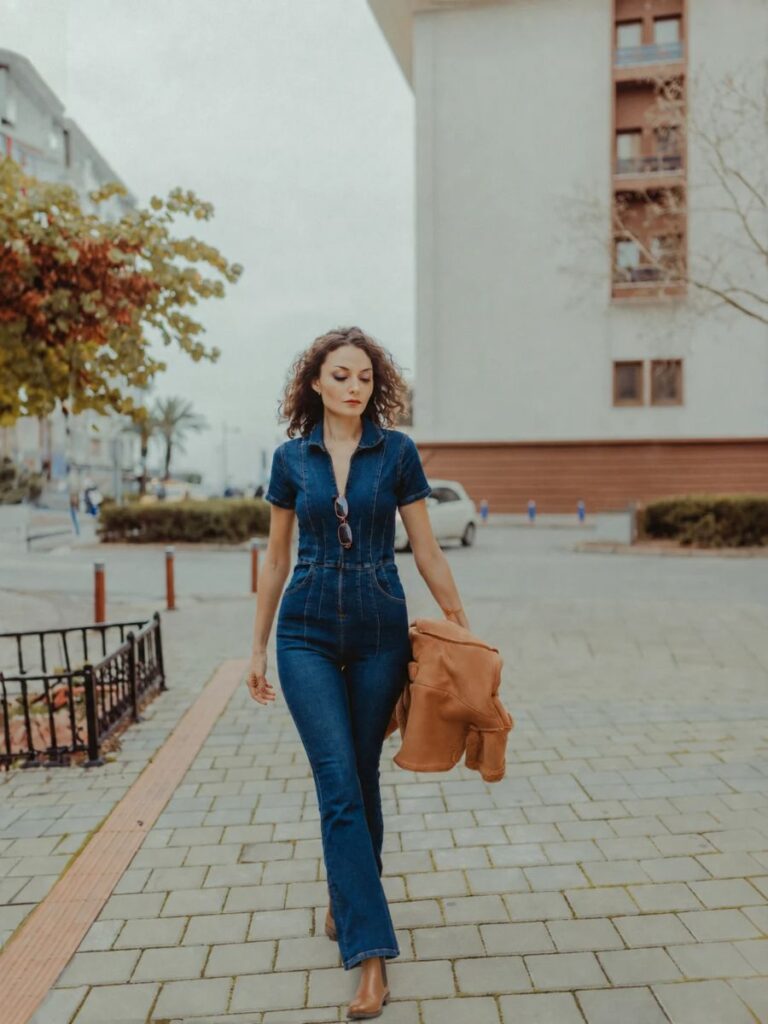 A Woman Walking in Jean Jumpsuit and Tan Brown Chelsea Boots